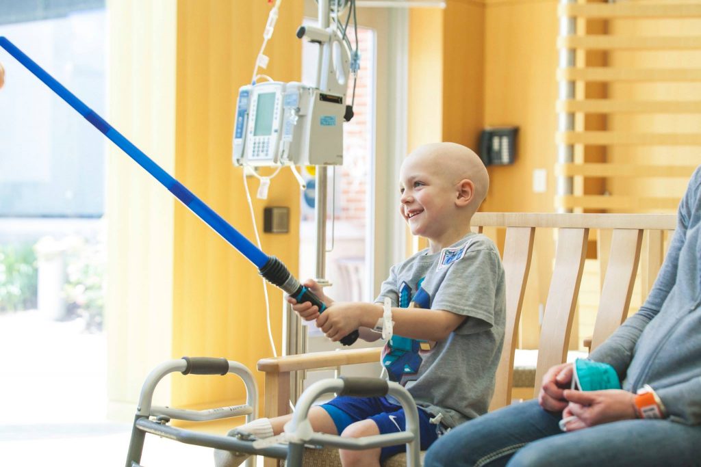 Child with lightsaber at Children's Mercy