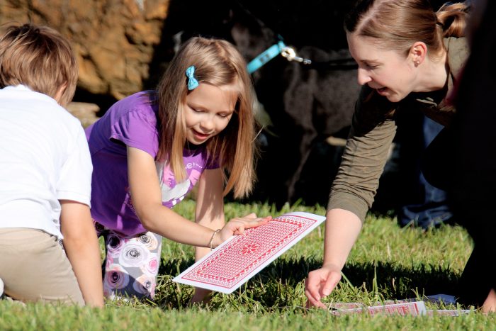 Kids do exercises with playing cards