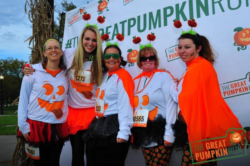 Women in pumpkin shirts and costumes at Great Pumpkin Run
